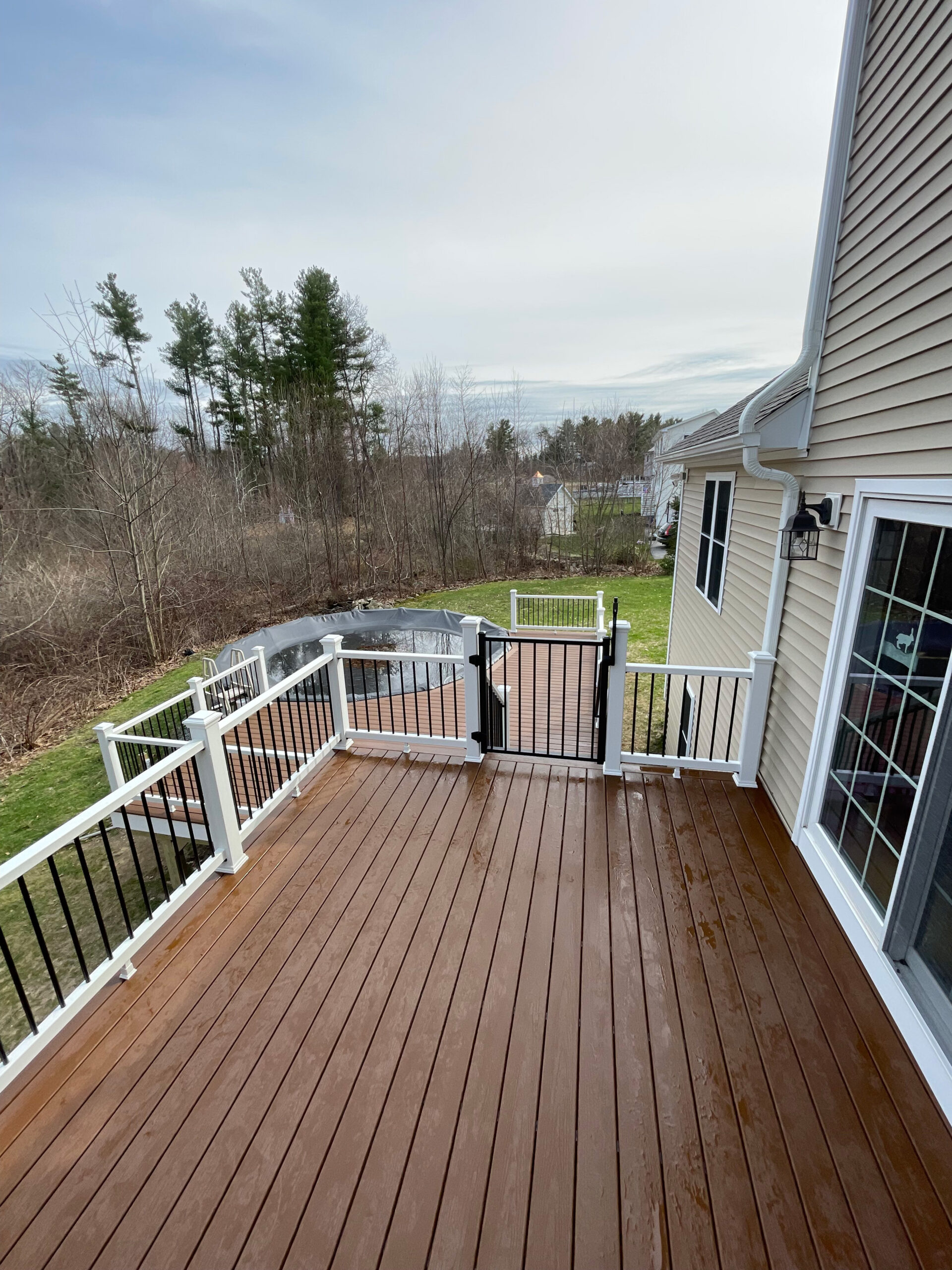 New deck build with trex saddle decking and white railings in Rutland MA.