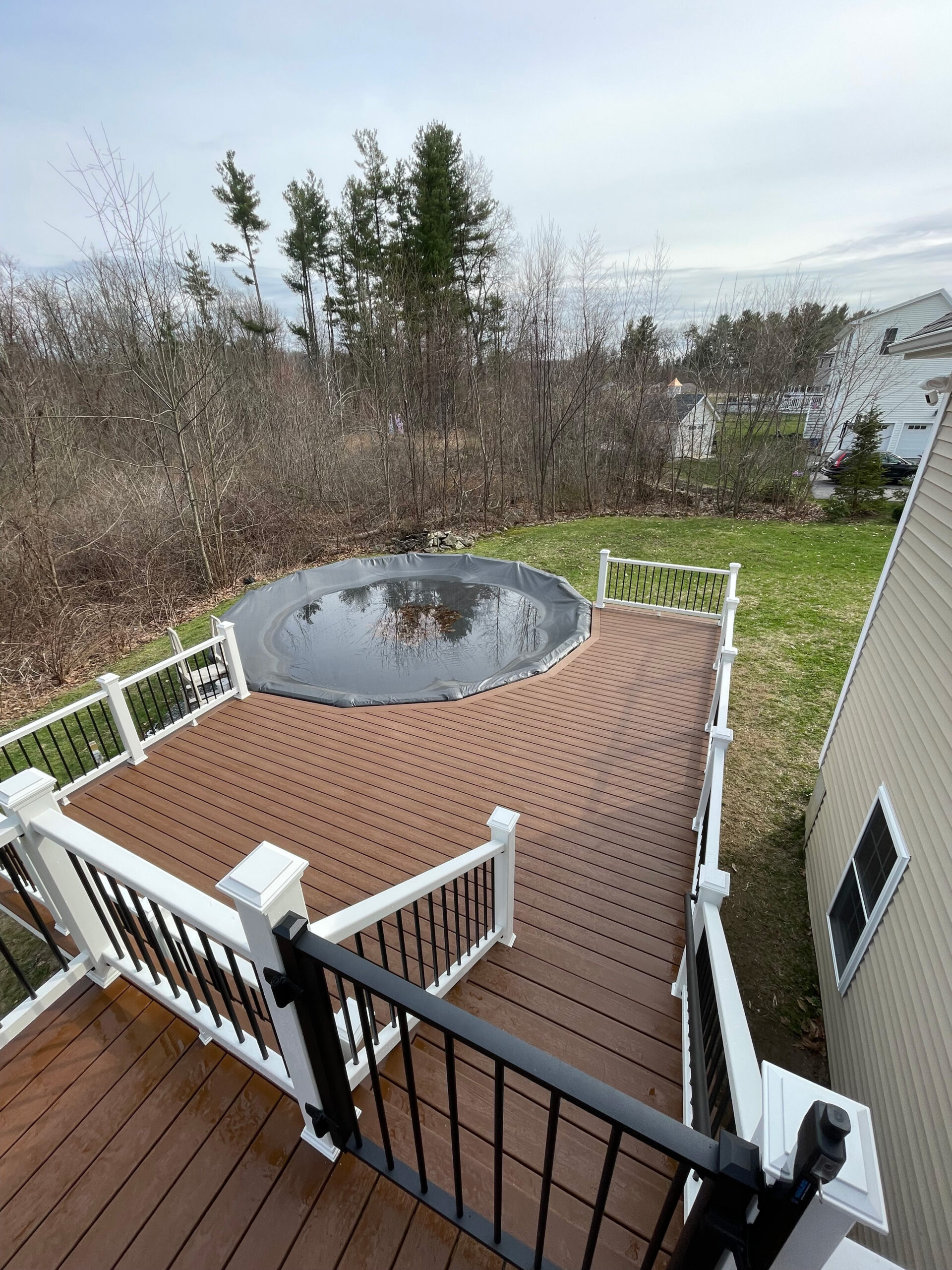 high up view of a deck built around a pool in rutland ma